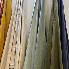 Collection of draped fabrics in various colors on a white background